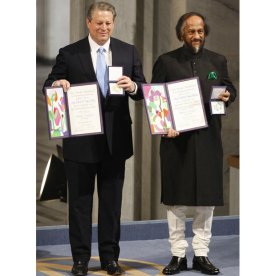 Nobel Peace Prize laureates, Rajendra Pachauri and Al Gore pose on the podium with their diplomas and gold medals