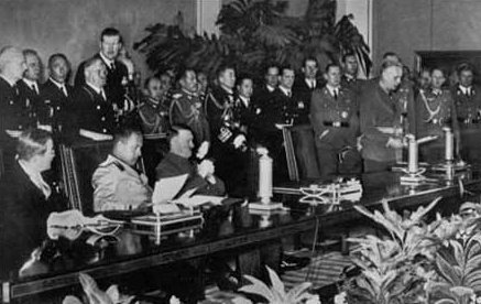 Signing of the Tripartite Pact. On the lefthand side of the picture, seated from left to right, are the signatories: Saburō Kurusu (representing Japan), Galeazzo Ciano (Italy) and Adolf Hitler (Germany). "Signing ceremony for the Axis Powers Tripartite Pact;" by Source. Licensed under Fair use via Wikipedia - http://en.wikipedia.org/wiki/File:Signing_ceremony_for_the_Axis_Powers_Tripartite_Pact;.jpg#mediaviewer/File:Signing_ceremony_for_the_Axis_Powers_Tripartite_Pact;.jpg