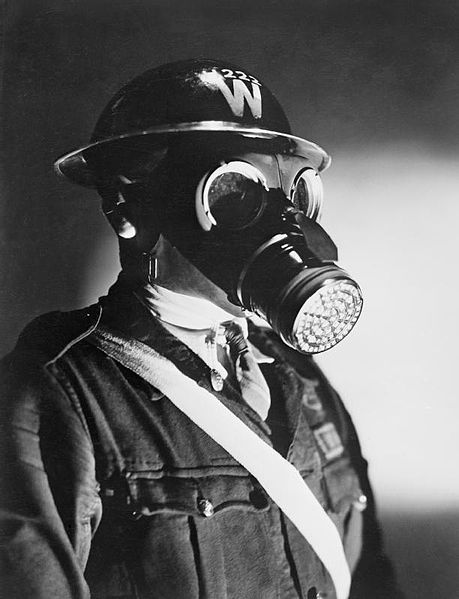 459px-An_Air_Raid_Warden_wearing_his_steel_helmet_and_duty_gas_mask_during_the_Second_World_War._D4053